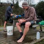 Brian McCleary (right) and Joe Hempel quickly bundle up to get warm Jan. 29 after completing their swim in Langley. (Olivia Vanni / The Herald)