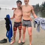 Whidbey athletes Cooper Ullmann, 18, and Kai Fawcett, 17, shed their shorts and wear boxer briefs to dunk in the Sound. (Andrea Brown / The Herald)