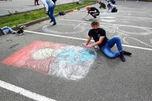 Photo by John Fisken
Christopher Hoppock was among 60 members of the Senior Class Council at Oak Harbor High School who took part in whimsical Chalk It Up fun and decorated the school parking lot. The event provided a simple, intentional moment for the class to get together safety and school officials predict it could be the start of a new tradition.