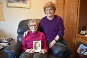 Frances Schultz, holding a picture of her younger self, recently turned 100 years old. Her daughter, Connie Van Dyke, right, said her mothers photo looks like one of actress Barbara Stanwyck. Photo by Emily Gilbert/Whidbey News-Times