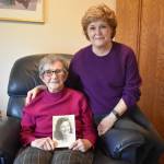 Frances Schultz, holding a picture of her younger self, recently turned 100 years old. Her daughter, Connie Van Dyke, right, said her mothers photo looks like one of actress Barbara Stanwyck. Photo by Emily Gilbert/Whidbey News-Times
