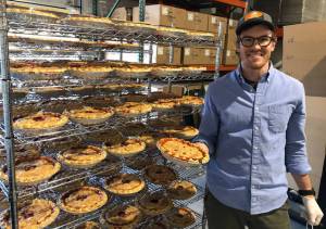 Joe Gunn holding a freshly backed rhubarb pie. (Photo by Harry Anderson)