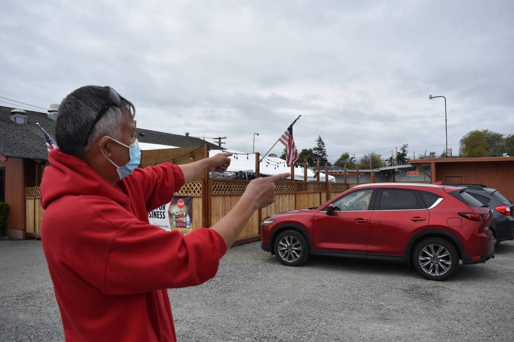 Owner of the Oak Harbor Cafe and Lounge Ken Huang points to the lounge section of the building that will be demolished in a few weeks. The outdoor dining area will stay and the parking lot will be paved. Photo by Emily Gilbert/Whidbey News-Times