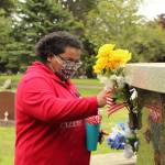 An Exceptional Academy student adorns a veteran's grave with an American flag at Maple Leaf Cemetery in Oak Harbor, May 17, 2021. (Photos by Karina Andrew/Whidbey News-Times)
