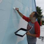 Jeremy Jarvis works on his mural in Langley. (Photo by Kira Erickson/Whidbey News-Times)