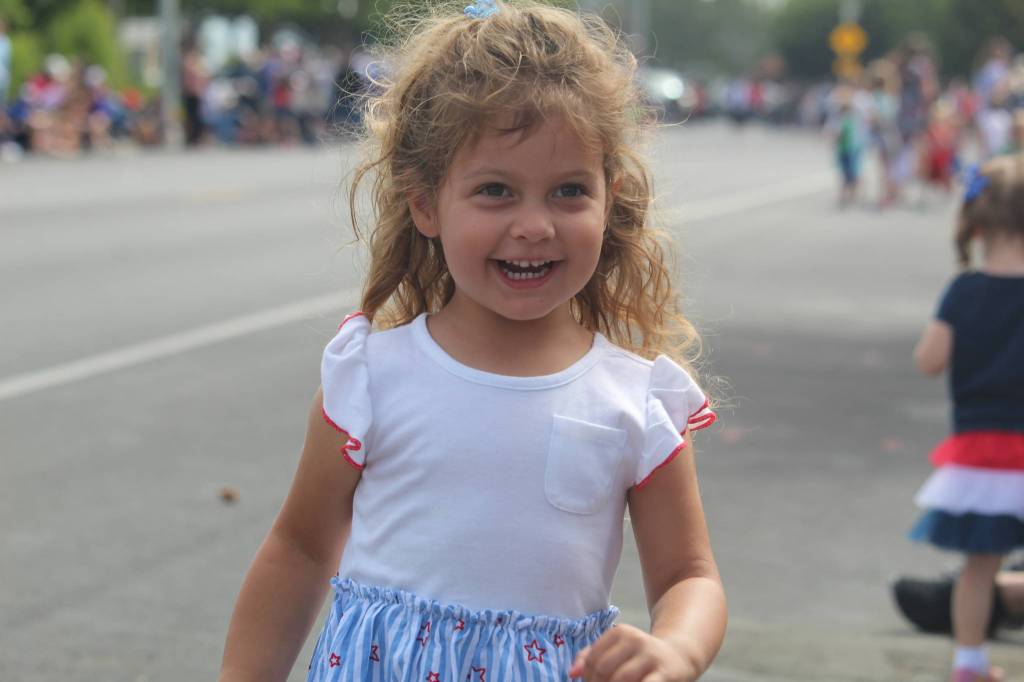 Sophie Amerine, 3, rushes back to her parents with her candy. (Photo by Karina Andrew/Whidbey News-Times)