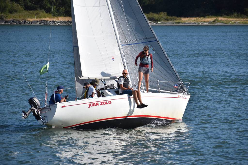 Photo by Emily Gilbert/Whidbey News-Times 
Dave Steckman talks to his crew aboard the <em>Juan Solo </em>during the Oak Harbor Yacht Clubs Thursday night race last week. Steckman said hes looking forward to the clubs new regatta, the Whidbey Summer Classic, this weekend.