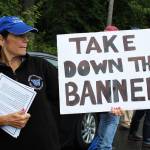Maureen Greene displays a sign and distributes informational papers opposing the Black Lives Matter banner at the June 11 protest. (Photo by Karina Andrew/Whidbey News-Times)