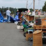 Photo by Karina Andrew/Whidbey News-Times
Volunteers cover up outdoor wares to protect them from rain.