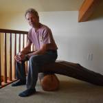 Photo by Emily Gilbert/Whidbey News-Times
Karl Nielsen sits on a log bench of his creation. The Oak Harbor resident will be bringing his work to Woodpalooza, a show for woodworkers taking place next weekend.