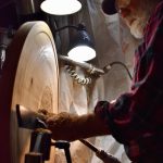 Jim Short working on a wall hanging made of cedar at his Coupeville home. (Photo by Emily Gilbert/Whidbey News-Times)