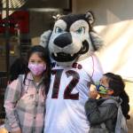 Isadora and Mateo Jimenez Campos stop for a picture with the wolf pup mascot. (Photo by Karina Andrew/Whidbey News-Times)