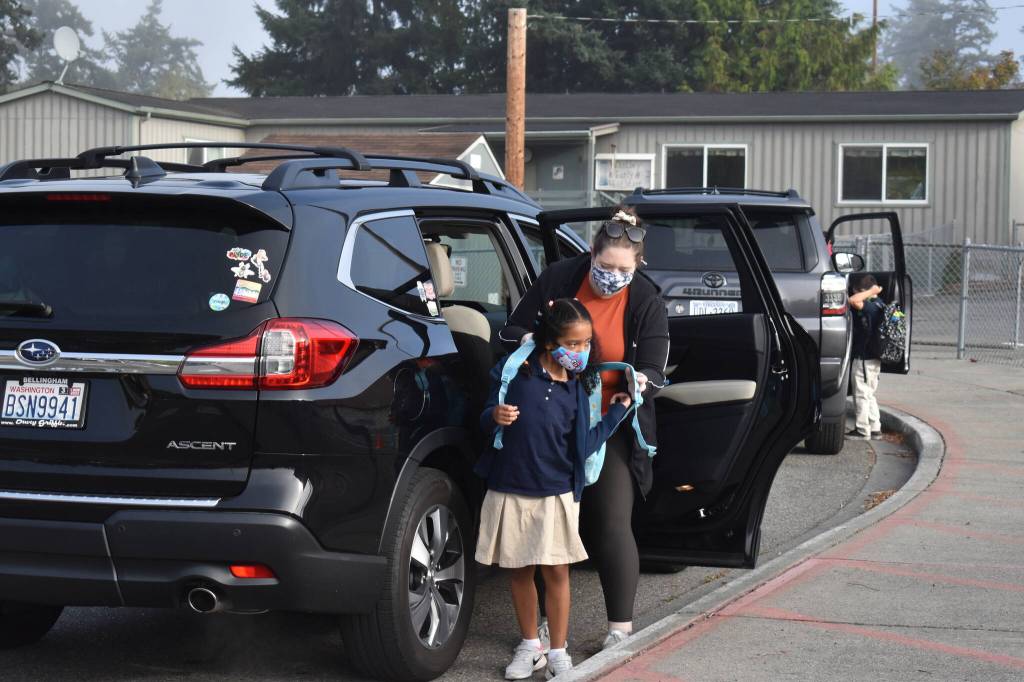 Photo by Emily Gilbert/Whidbey News-Times
Sienna Epps helps her daughter, Kaia, put on her backpack before walking onto campus at Oak Harbor Elementary on Sept. 9 for the first day of school.