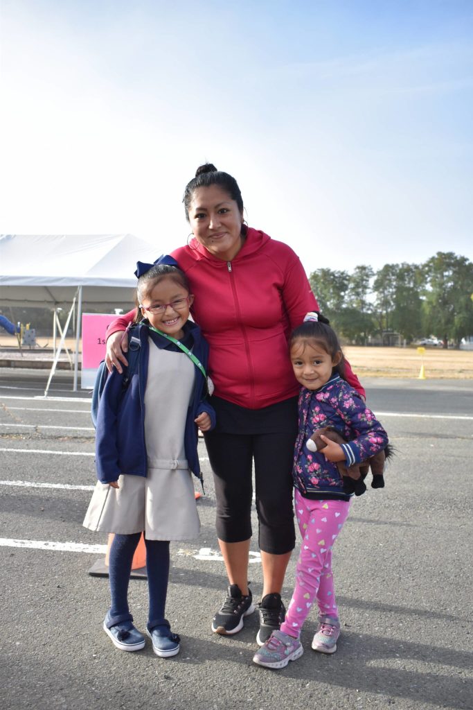 Above, Luz Huaromo and her younger daughter, Kamila Barajas, wish incoming first grader Lilian Barajas a good first day of school at Oak Harbor Elementary on Sept. 9.