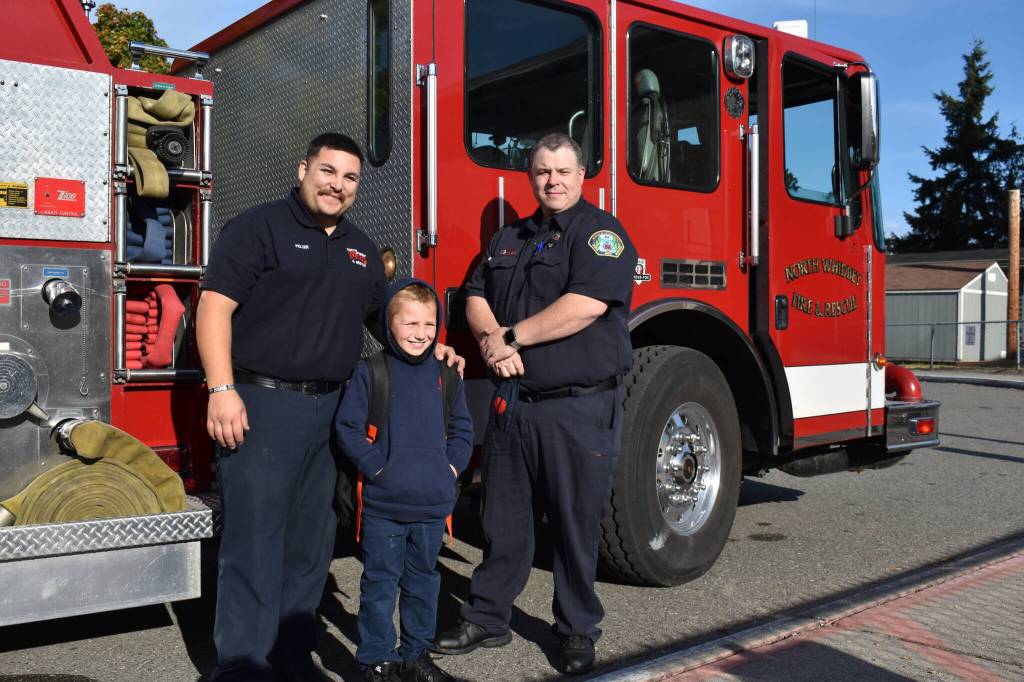 Left, Isaac Rico arrived to his first day of third grade at Oak Harbor Elementary on Sept. 9 escorted by North Whidbey Fire and Rescue firefighters Michael Pelzer and Jonathan Walker. Ricos father, Tyler Rico, worked with the fire district for seven years and passed away at the end of August.