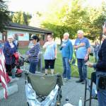 Community members stand and recite the Pledge of Allegiance while listening to a South Whidbey School District board meeting. (Photo by Karina Andrew/Whidbey News-Times)