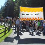 Students and community members march through Castle Park to demand climate justice. (Photo by Karina Andrew/Whidbey News-Times)