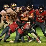 Photo by John Fisken
The Wolves tackle a Wolverine during a Oct. 28 heartbreaker.  Coupeville lost 13-6 to Friday Harbor in triple overtime.