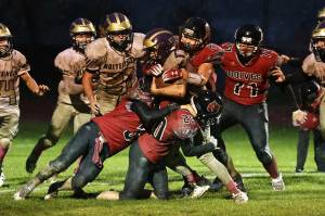 Photo by John Fisken
The Wolves tackle a Wolverine during a Oct. 28 heartbreaker.  Coupeville lost 13-6 to Friday Harbor in triple overtime.