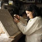 Photo by Kira Erickson/South Whidbey Record
Alexandra Morosco works on a relief carving in her studio. The art piece is a thank-you gift to the kennel where she found her faithful canine companion, a Tibetan mastiff.