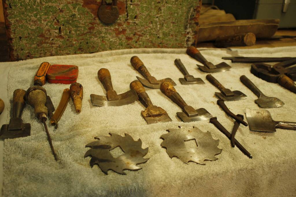 Tools used for patching plywood were recently discovered by South End picker John Norris. They could be over a century old, and include chisels, razors, nails and a hammer. (Photo by Kira Erickson/South Whidbey Record)