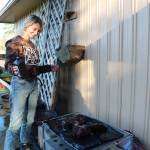 Photo by Karina Andrew/Whidbey News-Times
Nora Boehm sprays down T-shirts with water and bleach to create an effect inspired by the Japanese Shibori style of dyeing clothes. It is one of several ways in which Boehm upcycles clothing. One purpose of her art is to promote a sustainable lifestyle and cut off cycles of consumerism that rely on unethical production methods by encouraging people to upcycle and reuse clothing instead of throwing it away.