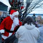Photo by Kira Erickson/South Whidbey Record
Santa Claus, played this year by Mark Stewart Cassidy, handed out gobs of candy canes to a crowd of children Saturday evening in Langley during the citys annual Tree Lighting Ceremony. The big jolly red man traveled to three different Christmas trees in the Village by the Seas downtown corridor.