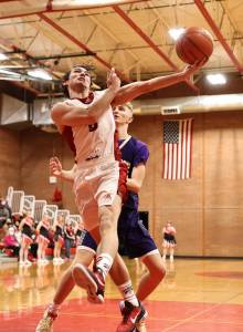 Photo by John Fisken
Coupeville High School senior Hawthorne Wolfe jumps for the hoop during a game against island rival Oak Harbor Wednesday. Coupeville came back from a 10-point deficit to win the first game of the year 70-64.