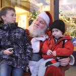 Photo by Karina Andrew/Whidbey News-Times
August Stohmire, 2, and his young uncle Ryan Brown, 9, meet Santa Claus Dec. 4. on Pioneer Way.