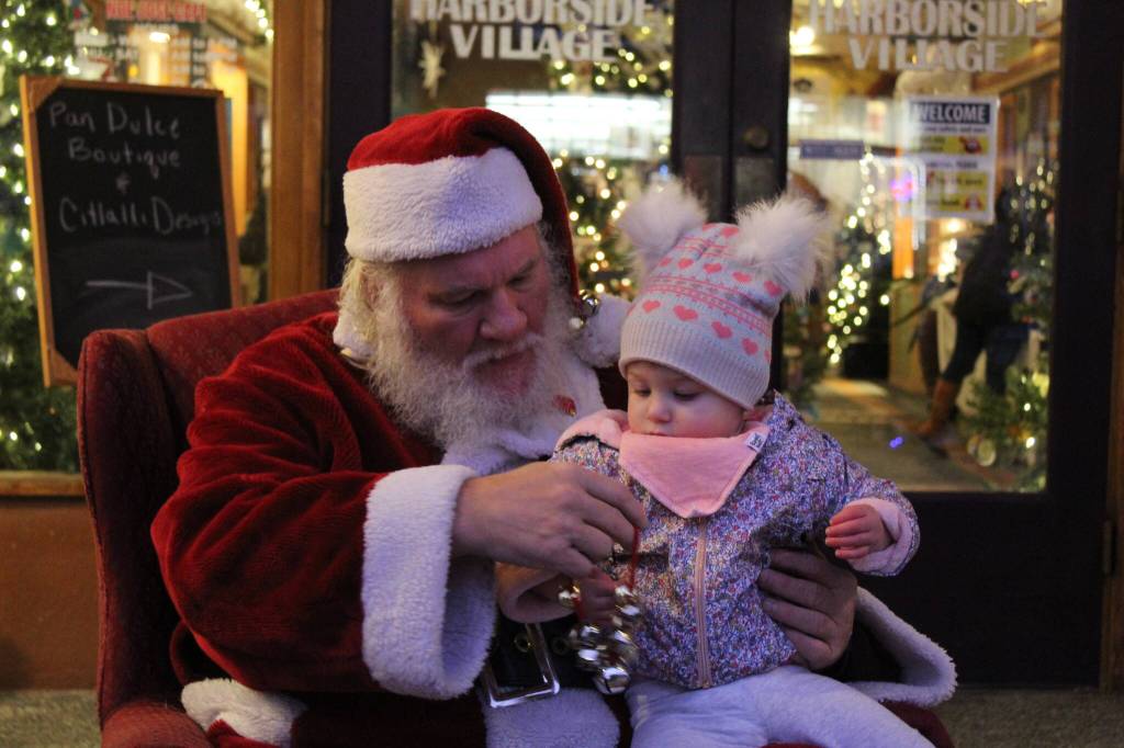 Photo by Karina Andrew/Whidbey News-Times
Noelle Hallquist, 16 months, sits on Santas lap Dec. 4 on Pioneer Way.
