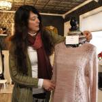 Photo by Kira Erickson/South Whidbey Record
Marsha Clark, owner of Skein and Tipple, adjusts a knitted sweater displayed on a mannequin within her store. Clark knitted all items seen within the boutique, from sweaters to hats to slippers.