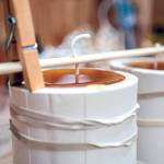 Freshly poured wax hardens in a candle mold. Lowry starts her process with 20-pound chunks of beeswax she buys from Northwest apiaries. (Olivia Vanni / The Herald)