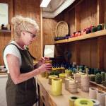 Priscilla Lowry makes candles at her workshop on south Whidbey Island. (Olivia Vanni / The Herald)