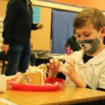Photo by Karina Andrew/Whidbey News-Times
Aiden Hogan gets his hands messy while constructing his gingerbread house.