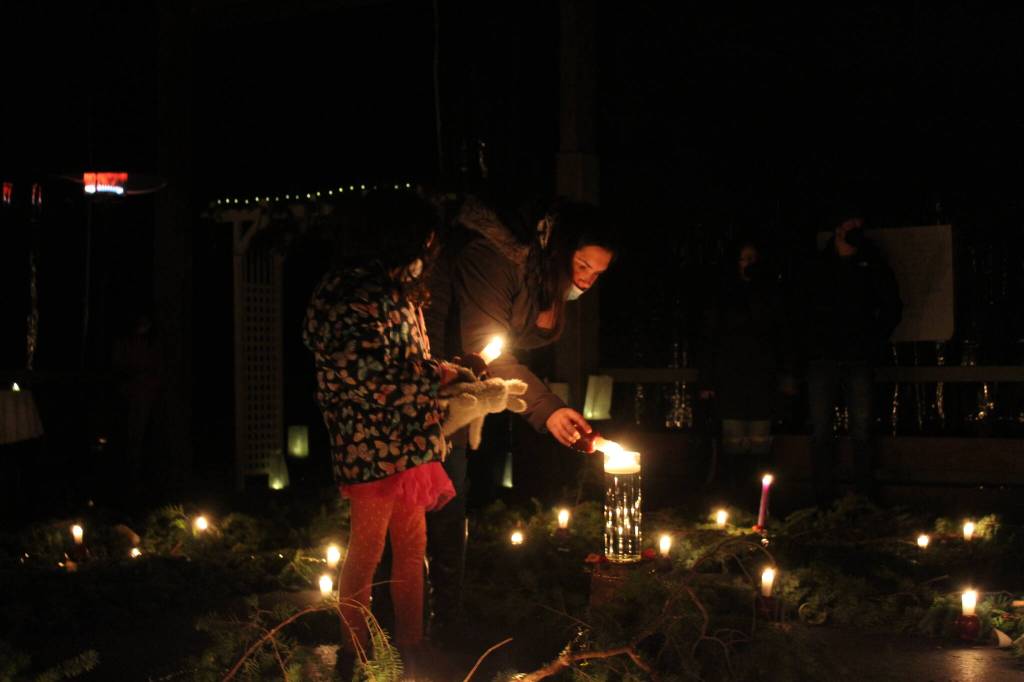 Photo by Karina Andrew/Whidbey News-Times
Visitors light their candles in the center of the spiral.