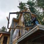 Photo by Dave Welton 
A construction crew prepares to install a window at a South Whidbey site.