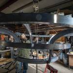 Photo by David Welton
Brendan McHugh uses a hoist to lower the 400-pound chandelier at the shop on Saratoga Road.