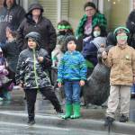 Oak Harbor children brave Thursdays rain to watch the St. Patricks Day parade in the hopes of getting some candy.
