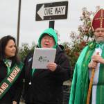 Parade Marshal Maria McGee, Pastor David Lura and Oak Harbors own St. Patrick give a blessing at the Blarney stone.