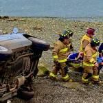 Photo provided
Firefighters carry a driver from the scene of a vehicle accident after the driver rolled his car near Penn Cove.