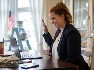 State Representative of the 38th Legislative District Emily Wicks raises hand during her virtual swearing in from her Everett home in January 2021. (Olivia Vanni / Herald file)