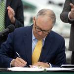 Ryan Berry / The Herald
Gov. Jay Inslee signs SB 5974 into law during a bill signing March 25 outside the ferry terminal in Mukilteo.