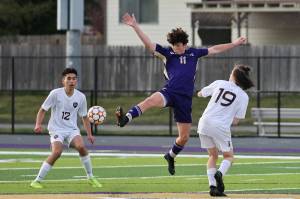 Photo by John Fisken
Oak Harbor High School soccer player Avi Salinger goes for the ball during a game against Bellingham April 14. Coach Tony Savoy said the team has faced challenges this season in the form of "nagging injuries." Despite these setbacks, he said the team remains competitive against the top teams in the standing. With five games left in the season, Oak Harbor is neck and neck with Ferndale, Savoy said.