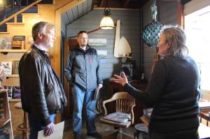 Photo by Karina Andrew/Whidbey News Group
<em>State Reps. Dave Paul, left, and Greg Gilday learn about the historic preservation work that took place in Kingfisher Bookstore from Meg Olsen, the stores owner. The original harbor door on the buildings lower level was used when the building housed a confectionary.</em>