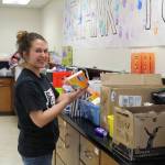 Photo by Karina Andrew/Whidbey News-Times
Arianna Bumgarner stocks soap and other hygiene products in Coupeville School Districts McKinney-Vento center.