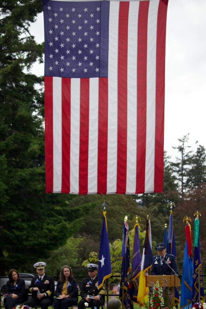 Major General Patricia Rose speaking beneath the American flag. (Photo by Rachel Rosen/Whidbey News-Times).