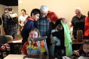 A family hugs after learning they were selected for home ownership through Habitat for Humanity. Relative and friends of the families selected attended the reveal to celebrate. (Photo by Karina Andrew/Whidbey News-Times)