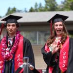 Photo by Karina Andrew/Whidbey News-Times
Eryn Wood, right, waves to the crowd as she walks in with fellow Coupeville graduate Hawthorne Wolfe.