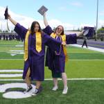 Photo by John Fisken
Lillian Sherwood and Lacey Bevill celebrate following the Oak Harbor High School graduation ceremony Saturday.