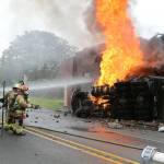 Photo by John Fisken
North Whidbey Fire and Rescue firefighters battle a blaze at Penn Cove Pottery after a semi truck crashed into the historic building Sunday morning.